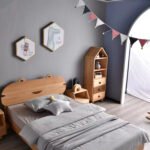 High angle view of Amyzel solid wooden single bed with bear eared headboard styled in kids bedroom with house storage rack