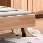 Detailed view of sturdy solid wood bed frame corner and wooden leg base for kids single bed