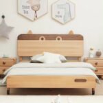 Direct front view of the animal-headboard wooden bed centered between two matching double-drawer nightstands.
