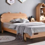 Perspective view of solid wood animal eared kids bed frame with grey bedding set next to house shaped bookshelf
