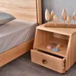 Amyzel solid wood kids nightstand bedside table with single drawer and open shelf featuring wooden tree toys decoration