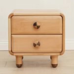 Close-up shot of the Amyzel children's wooden bedside table showing smooth rounded corner guards and dual drawers with round two-tone wood pulls.