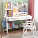 White wooden kids' study desk featuring an integrated top hutch shelf, a lower storage shelf, a side backpack hook, and a matching white wooden study chair with a grey upholstered cushion.
