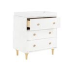 White modern 3-drawer chest of drawers with natural wood knobs and legs, featuring an open top drawer showing the interior storage space.