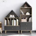 Pair of house-shaped charcoal grey and natural wood kids bookcases featuring vertical book slots, open shelving, and base storage drawers.