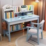 Pastel blue wooden kids' study desk and chair set, featuring a built-in top bookshelf hutch, white drawers, side backpack hook, and bottom storage shelf.