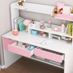 White and pink kids study workstation with pull-out pink desk drawers open to reveal internal storage compartments.