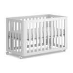 Pure white slatted wooden mobile baby crib on caster wheels, featuring smooth rounded corners and a plush white fitted mattress.