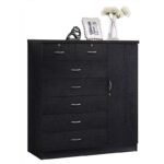 Lifestyle view of the black wood multi-drawer chest with side wardrobe cabinet, styled on top with a picture frame and a vase of flowers.
