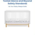 White slatted baby crib with a light wood base on a plain background, accompanied by text reading "Tested Above and Beyond Safety Standards".