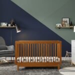 Wooden infant crib in modern nursery with slatted sides