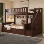 Walnut finish solid wood twin bunk bed, designed with right-side storage stairs, an integrated display bookshelf with a plush teddy bear, and bottom pull-out drawers.