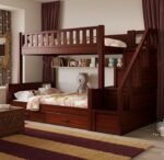 Premium mahogany finish wood kids bunk bed with a side staircase featuring built-in drawer steps, a long internal book storage shelf, and dual pull-out under-bed storage drawers.