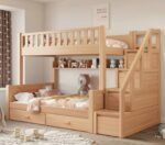 Premium pine finish solid wood twin bunk bed with integrated right-side storage stairs, a long open display shelf showcasing plush toys, and dual seamless under-bed pull-out drawers.