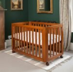 Warm natural honey brown wooden baby crib with wheels, movable slatted infant crib