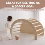 Wooden Montessori climbing arch set up on the floor as an interactive play tunnel and soccer goal target, shown with a toddler playing alongside.
