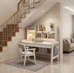 White wooden study table with built-in hutch bookshelf, ambient lighting, dual drawers, and matching cushioned white chair styled under a staircase.