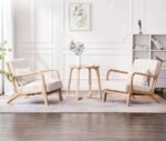 Pair of modern cream fabric accent chairs with light wood frames and matching wooden side table in bright living room setting