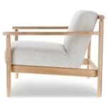 Side profile view of beige upholstered lounge chair featuring natural oak wood frame on white background
