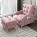 Soft pink plush recliner chair and footrest set accessorized with a cloud pillow in a cozy bedroom window reading nook.