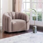 Taupe beige channel-upholstered swivel armchair placed by a large window in a bright living room setting with a small side table