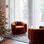 Pair of modern rust brown velvet channel-tufted swivel accent chairs arranged in a luxury living room around a fireplace decor setting