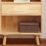 Close-up details of Amyzel natural solid wood kids storage cabinet showing smooth pull-out drawer, lower open shelf, and woven storage bin.