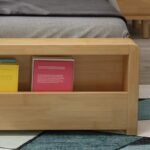 Close-up of the footboard shelf holding books.