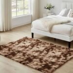 Brown and cream tie dye abstract shag area rug, variegated fluffy plush bedroom carpet, modern white low platform bed frame accent rug.