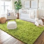 Amyzel bright lime green fluffy shag rug in a modern boho nursery, soft plush olive green area carpet styled with a white wooden baby crib, cream accent armchair, and macrame pouf.