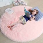 Light Pink circular fluffy rug for children's room, modern plush round shag carpet for nursery, soft minimalist kids floor accent mat.