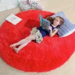 Vibrant red round fluffy shag rug for kids room, ultra soft circular plush nursery floor carpet, thick pile colorful children's play mat.