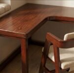 Close-up of solid wood L-shaped study table with polished finish